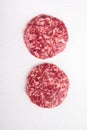 Fresh raw minced homemade farmers beef burgers cutlets, on white stone  background, top view flat lay Royalty Free Stock Photo