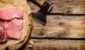Fresh raw minced meat with an axe. Royalty Free Stock Photo