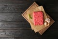 Fresh raw minced meat on black wooden table. Space for text Royalty Free Stock Photo