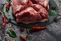 Fresh raw mutton shoulder meat isolated on black stone background with spices Royalty Free Stock Photo