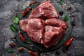 Fresh raw mutton shoulder meat isolated on black stone background with spices Royalty Free Stock Photo