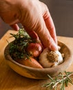 Fresh raw onions, garlic, rosemary closeup in wooden bowl Royalty Free Stock Photo