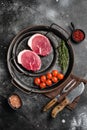 Fresh raw organic beef steak, on black dark stone table background, top view flat lay Royalty Free Stock Photo