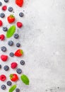 Fresh raw organic berries on kitchen table background. Space for text. Top view. Strawberry, Raspberry, Blueberry and Mint leaf Royalty Free Stock Photo