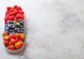 Fresh raw organic berries in in stainless steel tray on kitchen table background. Space for text. Top view. Strawberry, Raspberry Royalty Free Stock Photo