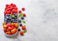 Fresh raw organic berries in in stainless steel tray on kitchen table background. Space for text. Top view. Strawberry, Raspberry Royalty Free Stock Photo