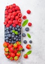 Fresh raw organic berries in in stainless steel tray on kitchen table background. Space for text. Top view. Strawberry, Raspberry Royalty Free Stock Photo