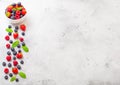 Fresh raw organic berries in white ceramic bowl plate on kitchen table background. Space for text. Top view. Strawberry, Raspberry Royalty Free Stock Photo