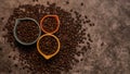 Fresh raw organic coffee beans in many colorful cups with varied sizes scattered on a slate countertop