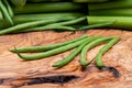 Fresh Raw Organic French Green Beans Haricot Verts, or Filet Beans on olive wood. Royalty Free Stock Photo