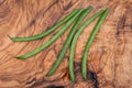 Fresh Raw Organic French Green Beans Haricot Verts, or Filet Beans on olive wood. Royalty Free Stock Photo