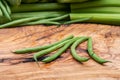Fresh Raw Organic French Green Beans Haricot Verts, or Filet Beans on olive wood. Royalty Free Stock Photo