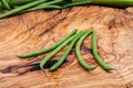 Fresh Raw Organic French Green Beans Haricot Verts, or Filet Beans on olive wood. Royalty Free Stock Photo