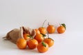 Fresh raw organic Tangerines with green leaves in bag on white wooden table.Copy space . Rich of nutrients, fiber, and Royalty Free Stock Photo