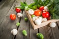 Fresh raw organic vegetables on a rustic wooden table in basket: spinach, broccoli, Brussels Royalty Free Stock Photo