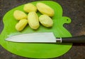 fresh raw peeled potatoes on a rustic wooden kitchen cutting board Royalty Free Stock Photo