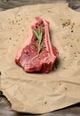 Fresh raw piece of beef meat, striploin steak on a paper background, top view. Marbled piece of meat