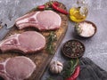 Fresh raw pieces meat pork, beef, chop on a bone on the board, spices Royalty Free Stock Photo