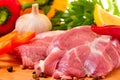 Fresh raw pork on board with fresh, vegetables Royalty Free Stock Photo