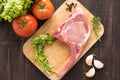 Fresh Raw Pork Chops and vegetable on wooden background. Royalty Free Stock Photo