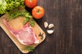 Fresh Raw Pork Chops and vegetable on wooden background. Royalty Free Stock Photo