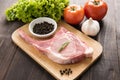 Fresh Raw Pork Chops and vegetable on wooden background. Royalty Free Stock Photo