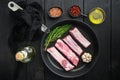 Fresh raw pork meat from organic farm with spices, in cast iron frying pan, top view flat lay Royalty Free Stock Photo