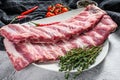 Fresh raw pork ribs with spices and herbs. Gray background. Top view Royalty Free Stock Photo