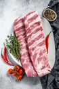 Fresh raw pork ribs with spices and herbs. Gray background. Top view Royalty Free Stock Photo