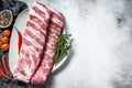 Fresh raw pork ribs with spices and herbs. Gray background. Top view. Copy space Royalty Free Stock Photo