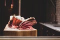 Fresh raw pork rips on wooden table in butcher shop showing on window. Royalty Free Stock Photo