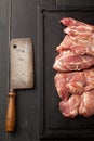 Fresh raw pork steak, knife and ax