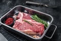 Fresh Raw porterhouse T bone beef meat Steak in steel tray with herbs. Black background. Top view Royalty Free Stock Photo