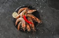 Fresh raw prawns or shrimps with spices on slate stone on dark stone background. Seafood, top view, flat lay, copy space Royalty Free Stock Photo