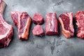 Fresh raw Prime Black Angus beef marbled and dry aged steaks, tomahawk, t bone, club steak, rib eye and tenderloin cuts, on gray Royalty Free Stock Photo