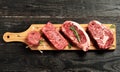 Fresh raw Prime Black Angus beef steaks on wooden board Royalty Free Stock Photo