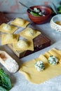 Fresh Raw Ravioli with Ricotta and Spinach on a blue background. Homemade raw uncooked italian pasta ravioli. Royalty Free Stock Photo