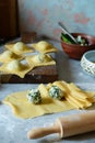 Fresh Raw Ravioli with Ricotta and Spinach on a blue background. Homemade raw uncooked italian pasta ravioli. Royalty Free Stock Photo