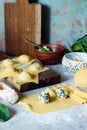 Fresh Raw Ravioli with Ricotta and Spinach on a blue background. Homemade raw uncooked italian pasta ravioli. Royalty Free Stock Photo