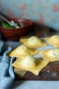 Fresh Raw Ravioli with Ricotta and Spinach on a blue background. Homemade raw uncooked italian pasta ravioli. Royalty Free Stock Photo