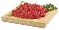 Fresh raw red cubed meat chunk on wooden cut board isolated over white background Royalty Free Stock Photo