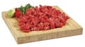 Fresh raw red cubed meat chunk on wooden cut board isolated over white background