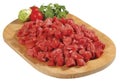 Fresh raw red cubed meat chunk on wooden cut board isolated over white background