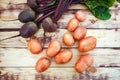 Fresh red potatoes and beets on wooden board. Top view Royalty Free Stock Photo