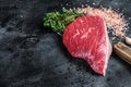 Fresh Raw rump beef cut or top sirloin cap steak on butcher cleaver. Black background. Top view. Copy space Royalty Free Stock Photo
