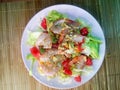 Fresh raw  salad with lettuce, tiger  shrimps and grapefruit  with sour sauce at pink plate. close up. Flat lay Royalty Free Stock Photo