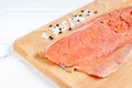 Fresh raw salmon fille. Red fish with salt and pepper Royalty Free Stock Photo