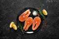 Fresh raw salmon fish steaks with cooking ingredients on kitchen table, healthy food, source of omega-3 Royalty Free Stock Photo