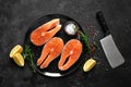 Fresh raw salmon fish steaks with cooking ingredients on kitchen table, healthy food, source of omega-3 Royalty Free Stock Photo