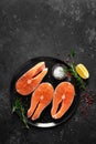 Fresh raw salmon fish steaks with cooking ingredients on kitchen table, healthy food, source of omega-3